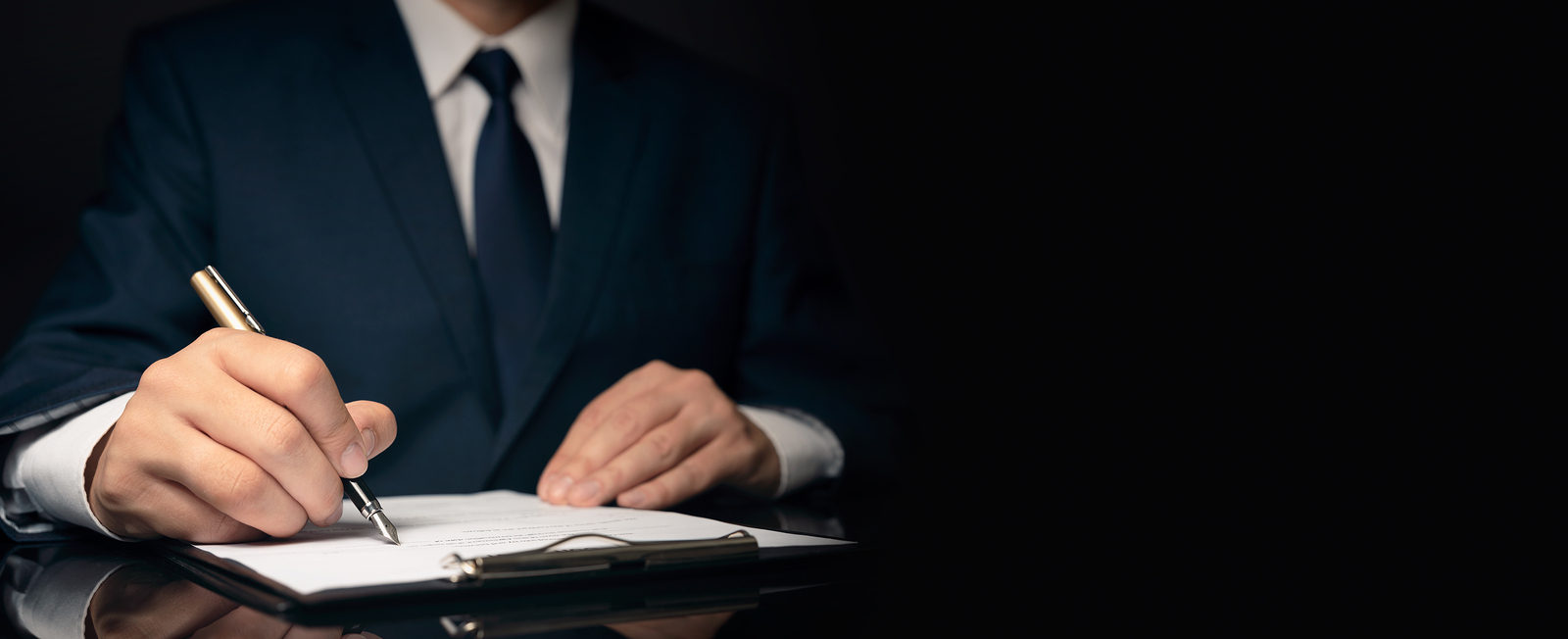 image of man signing paper